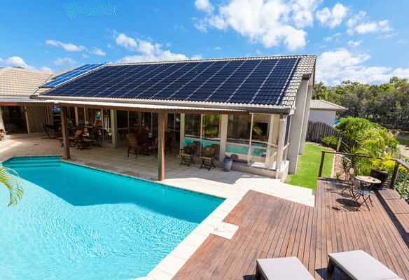 Residential rooftop solar installation with a poolside view